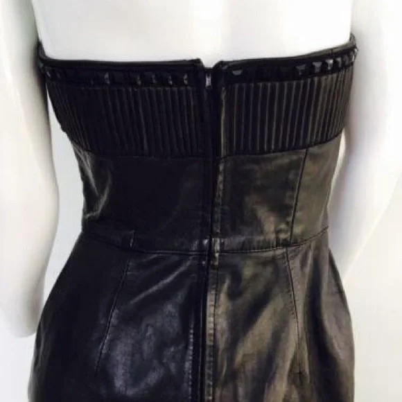 Black leather  strapless dress. 

Features a sweetheart plunge cleavage. - Picture 9 of 11